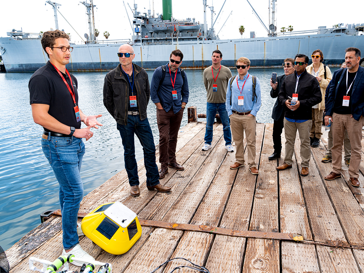 A group of people listens to a new technology presentation at Braid Space at AltaSea