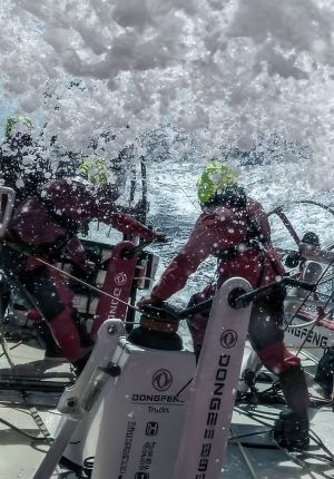 Offshore racing crew in maroon foul weather gear.